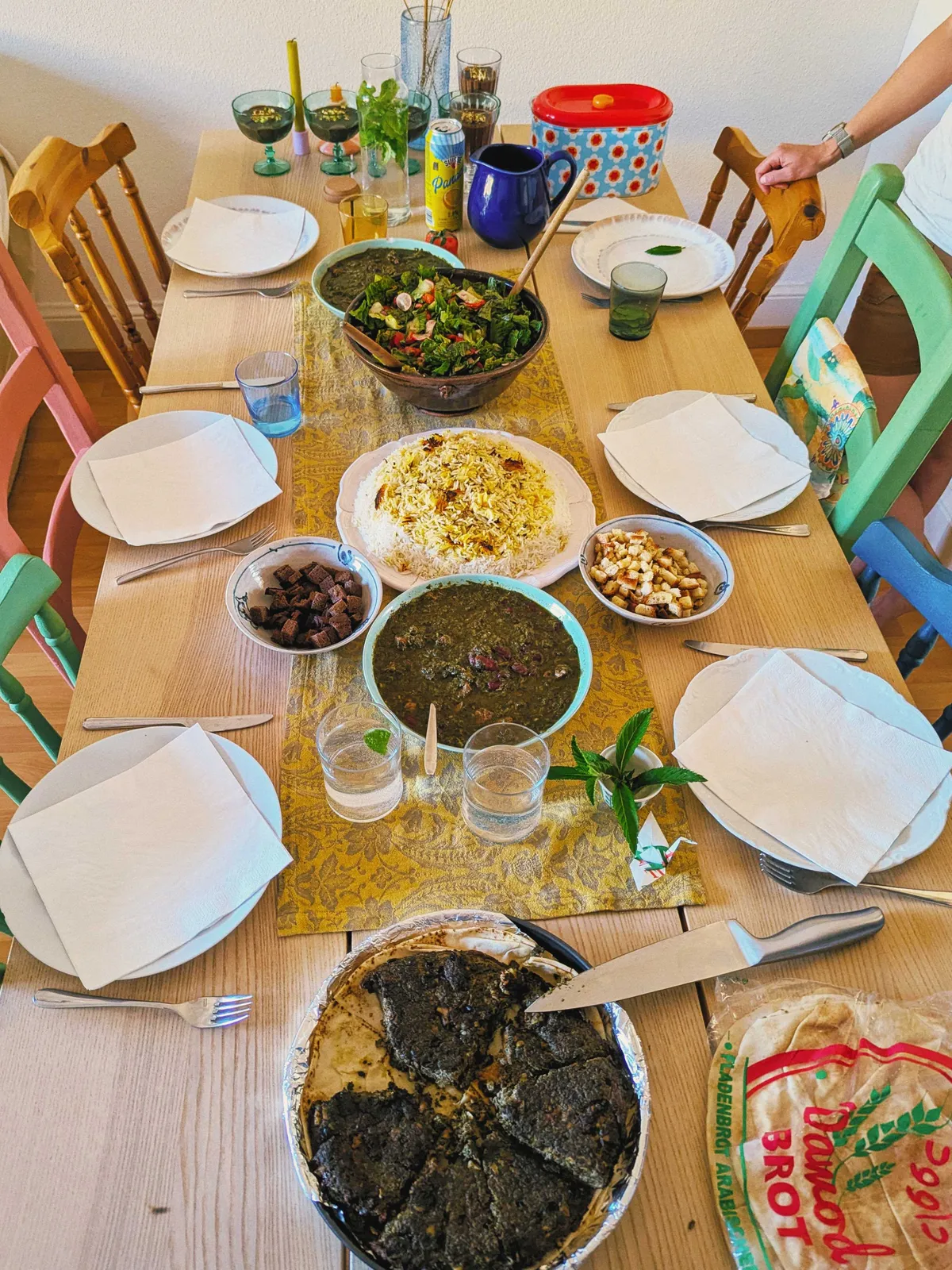 A table with salad and Persian dishes.