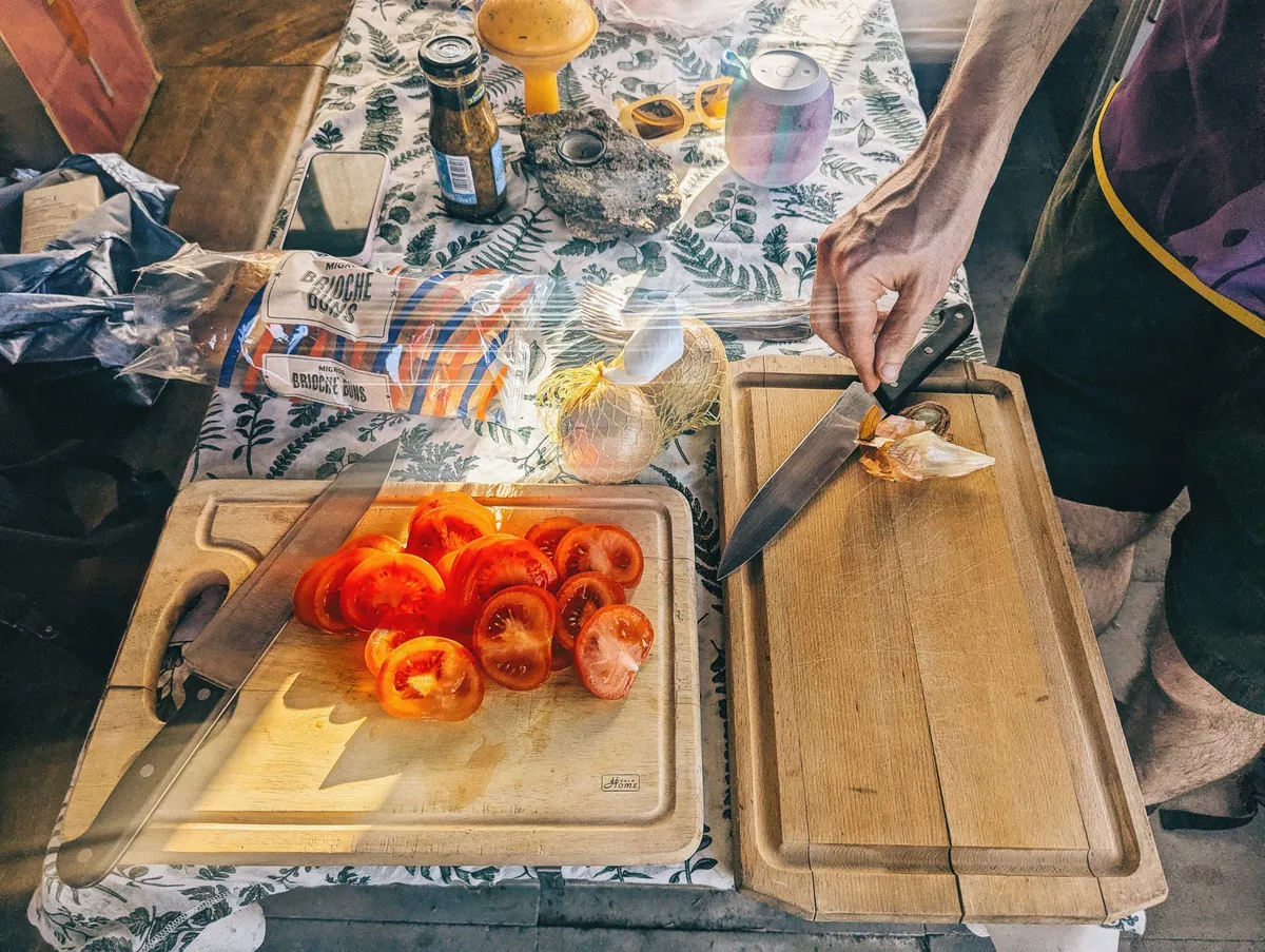 Daniel and I slicing tomatoes and onions.
