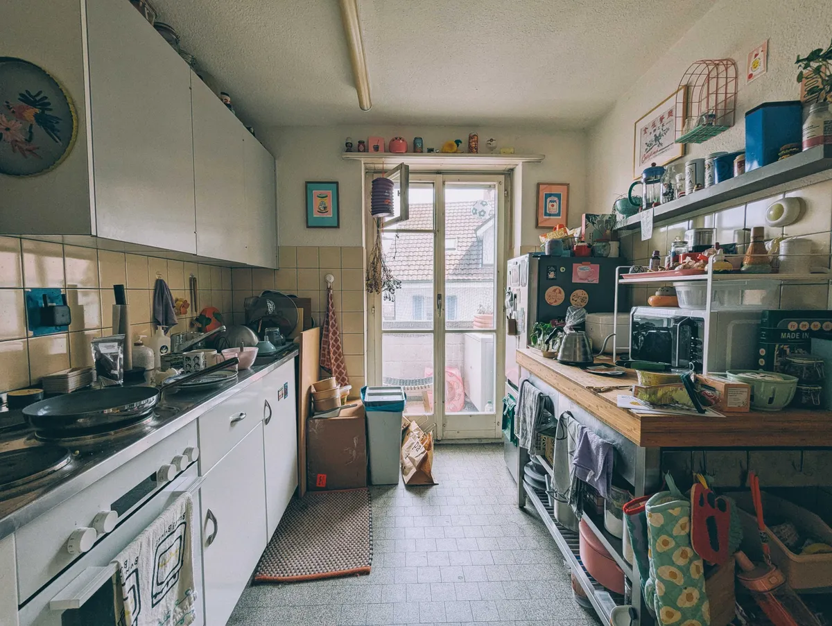 Kitchen with cluttered counters.
