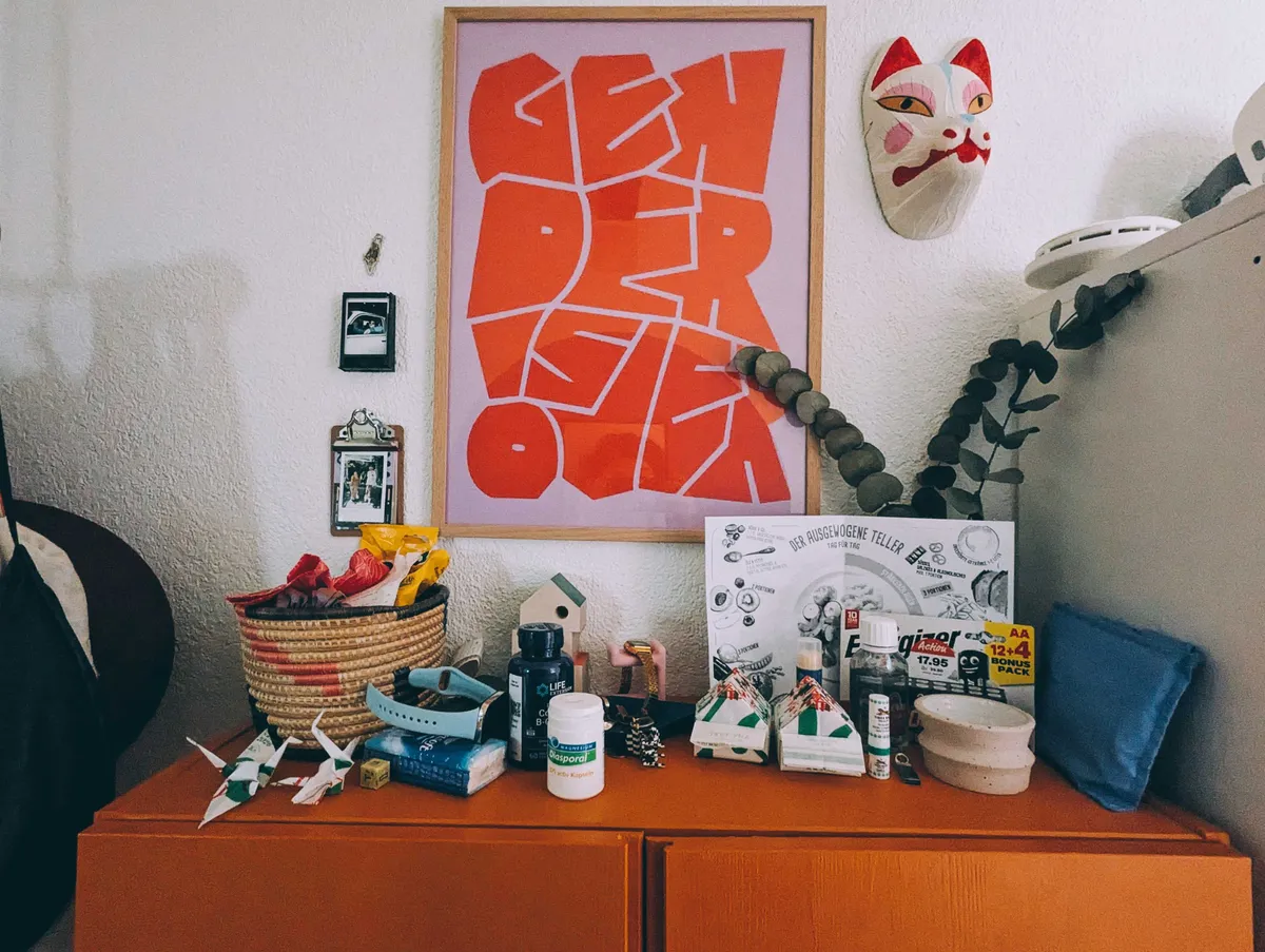 The top of an orange cabinet cluttered with random things.
