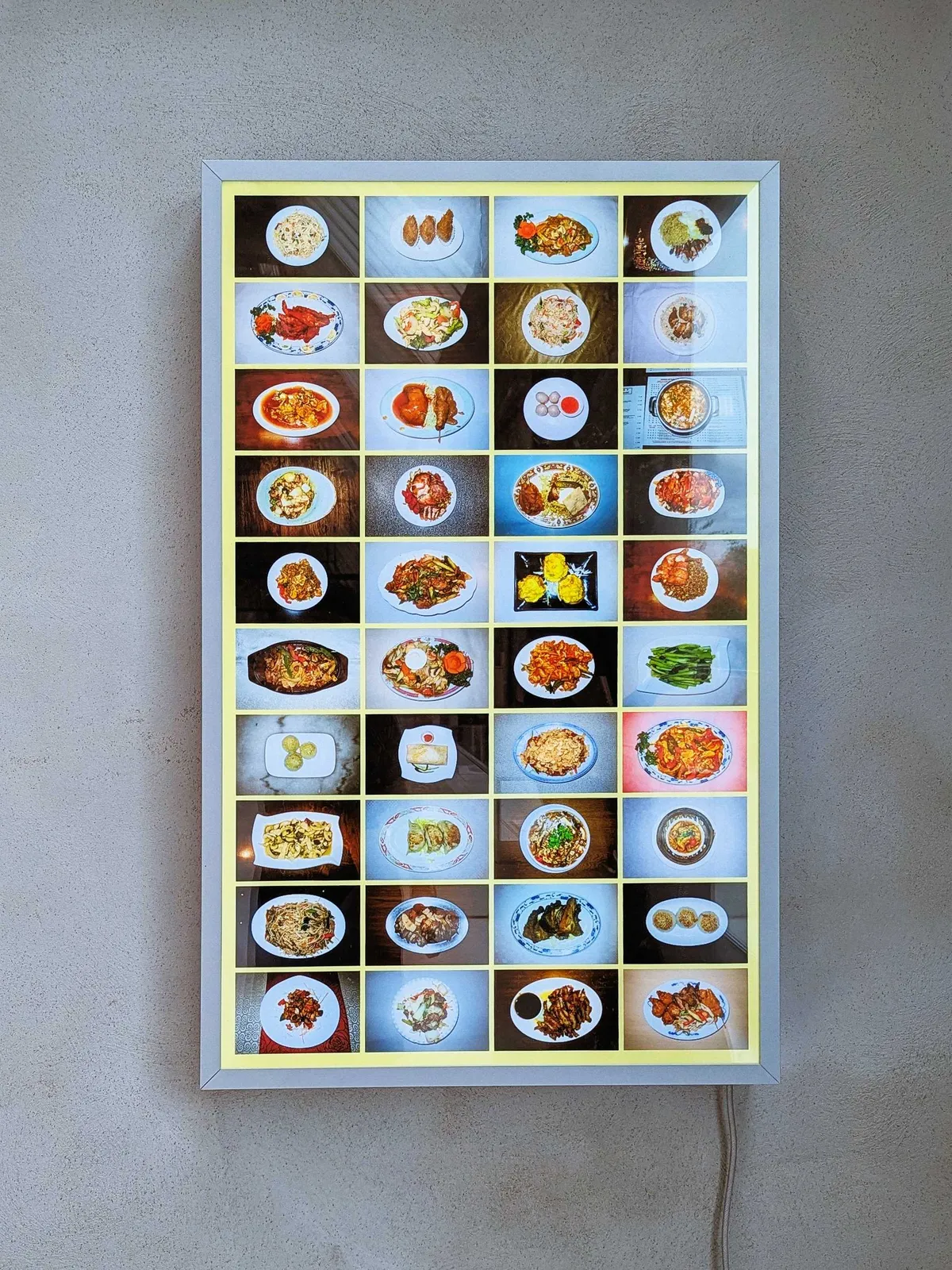 A lightbox lit up with photos of Chinese dishes, displayed in a 4x10 grid.
