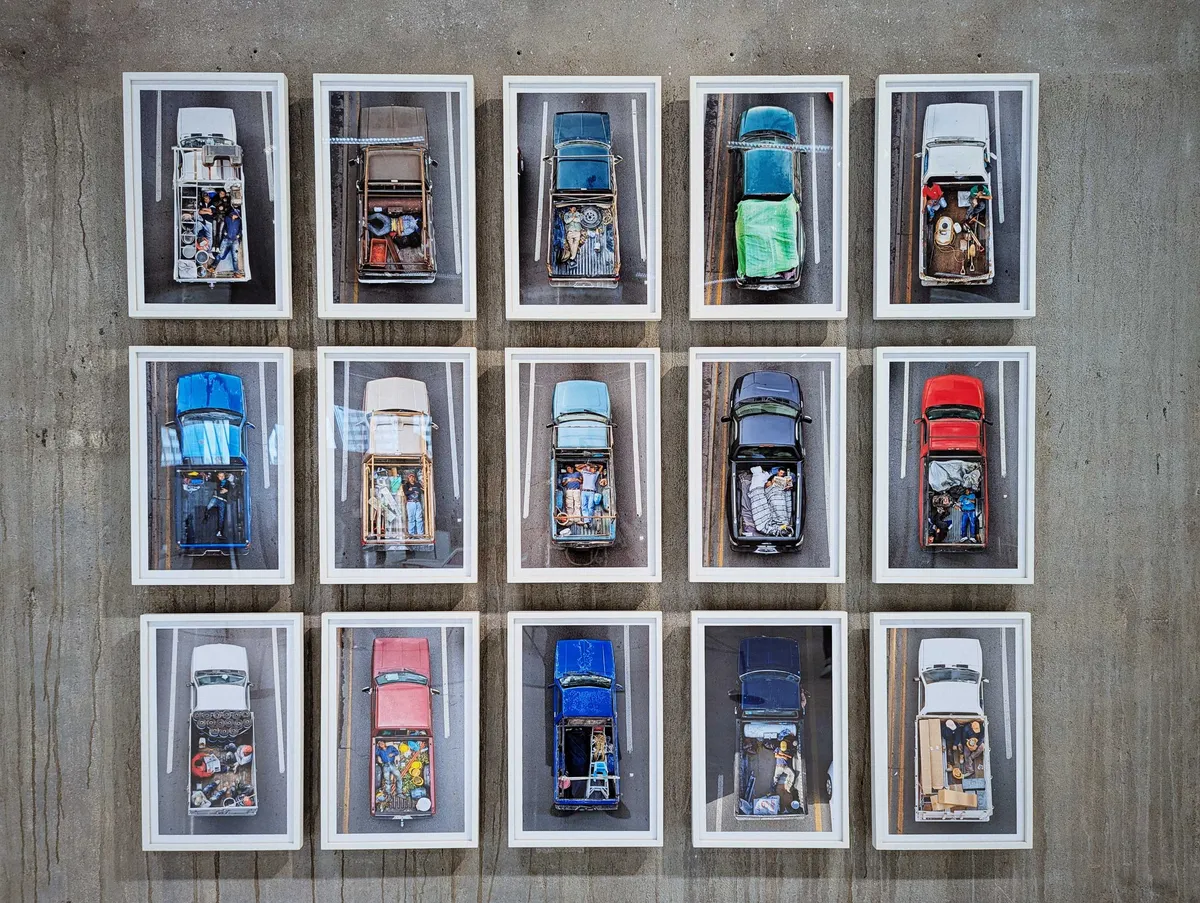 A series of portraits of pickup trucks shot from a birdseye view, showing migrant workers sleeping in the backs of the trucks.