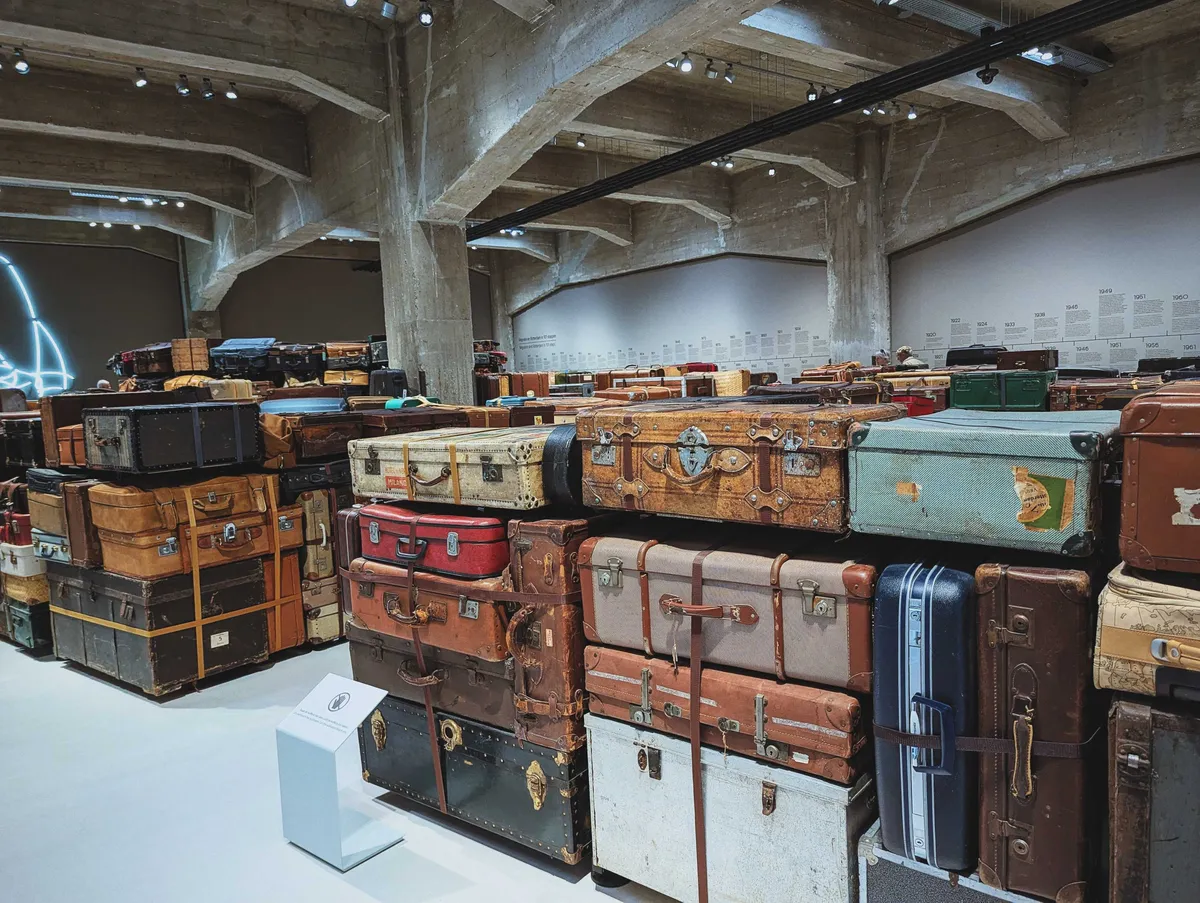 Blocks of suitcases from various eras tied together to form walls, creating a large maze.