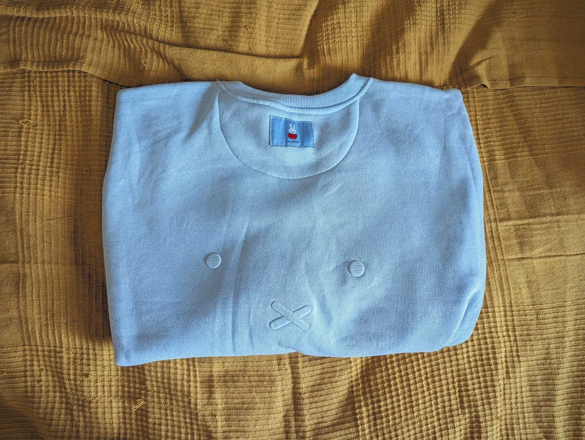 Miffy's eyes and nose-mouth embroidered onto the back of the sweater.