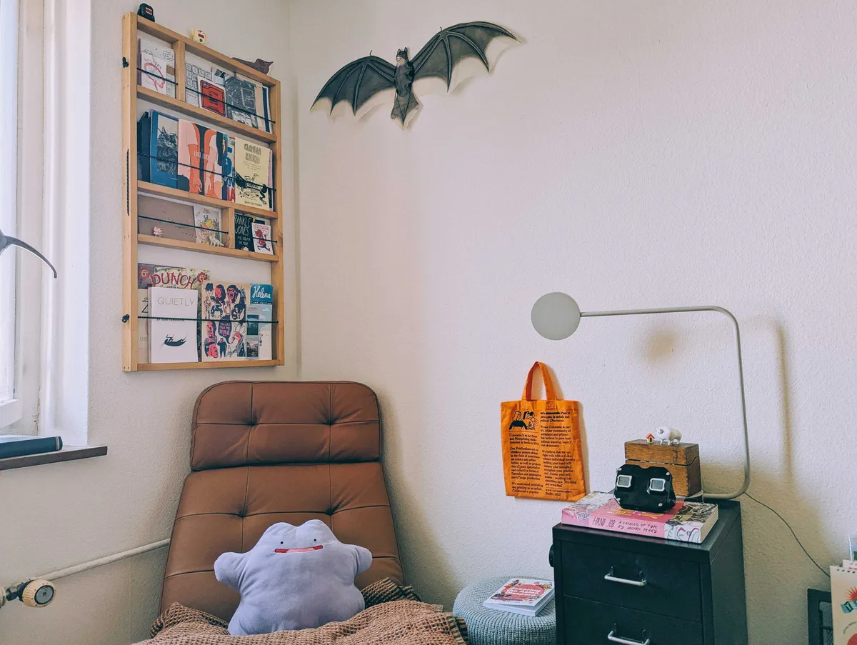 A more complete reading nook with the shelf on the left wall, the recliner in its position, and a detailed bat 