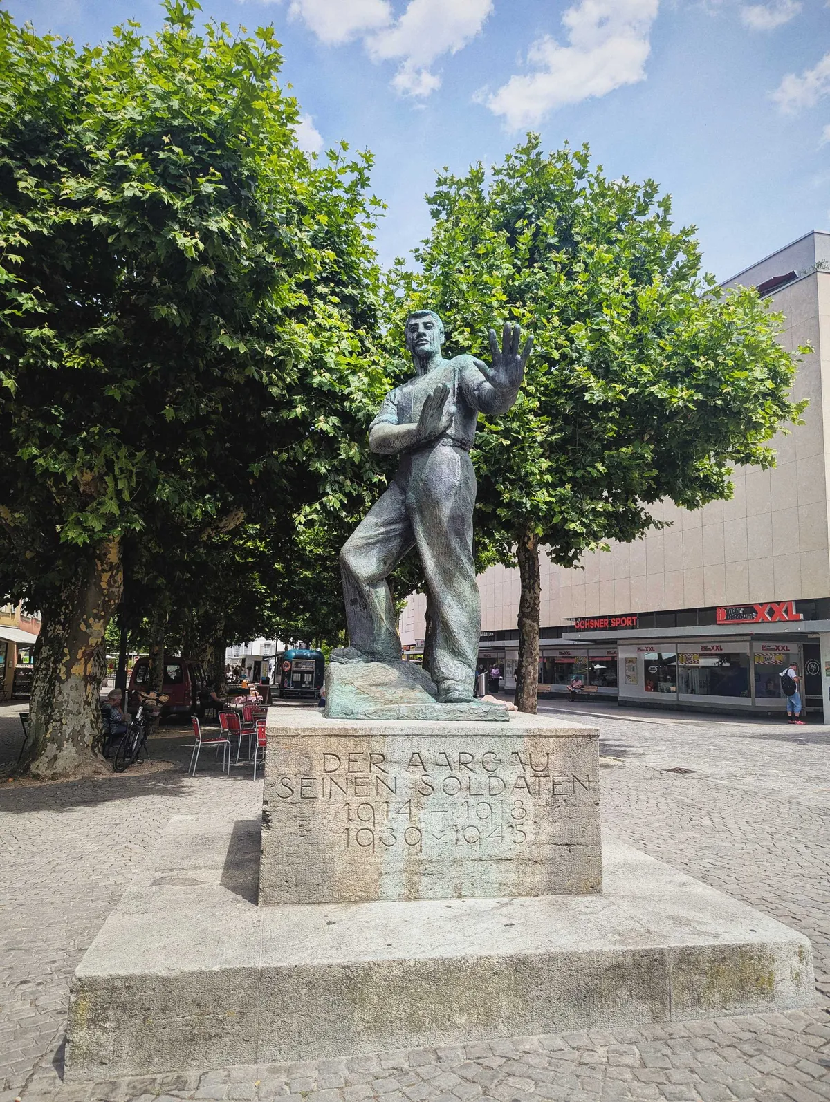 Statue of a solider who seems to be pushing something away.
