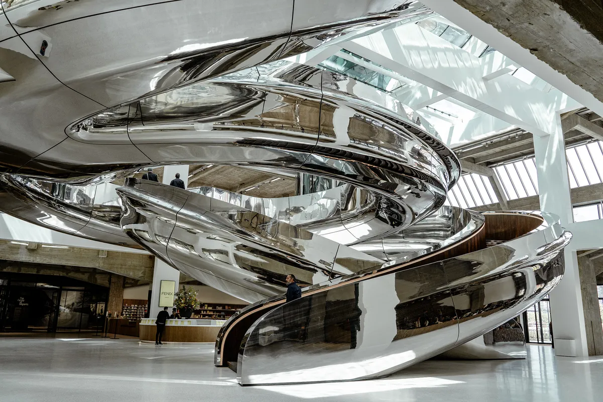 The metal silver spiral are staircases that wind all the way down into the interior of the building.