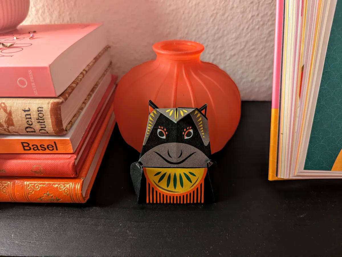 A black horse with yellow and red decorations. It has a smug smile.