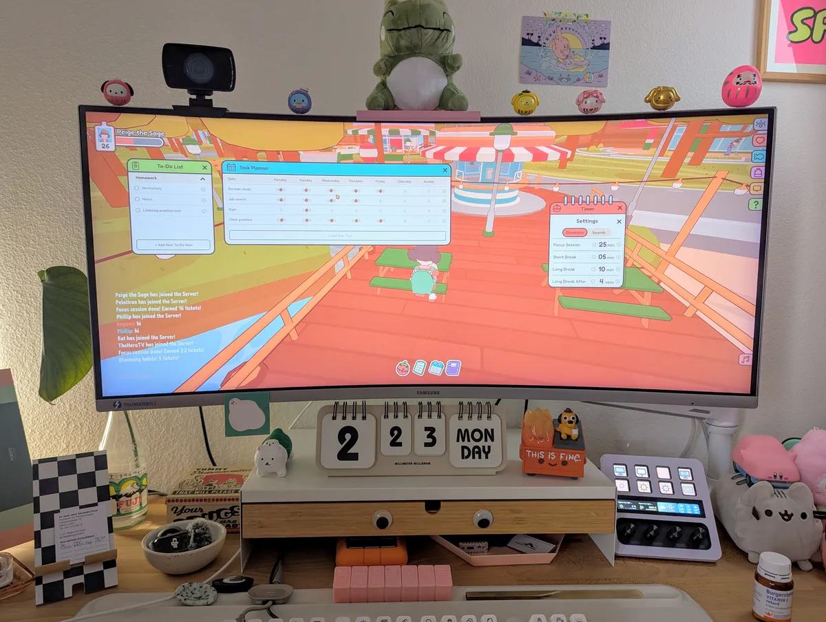Desk filled with cute things. The monitor is showing the game, "On-Together."