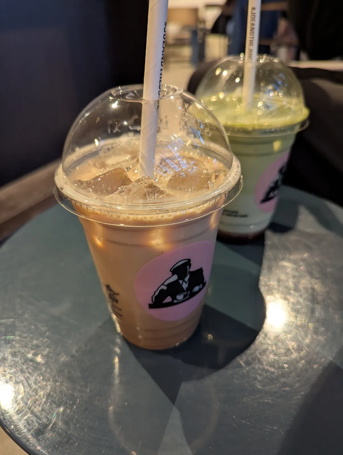 An iced chai latte from Joe and the Juice and a matcha drink behind that.