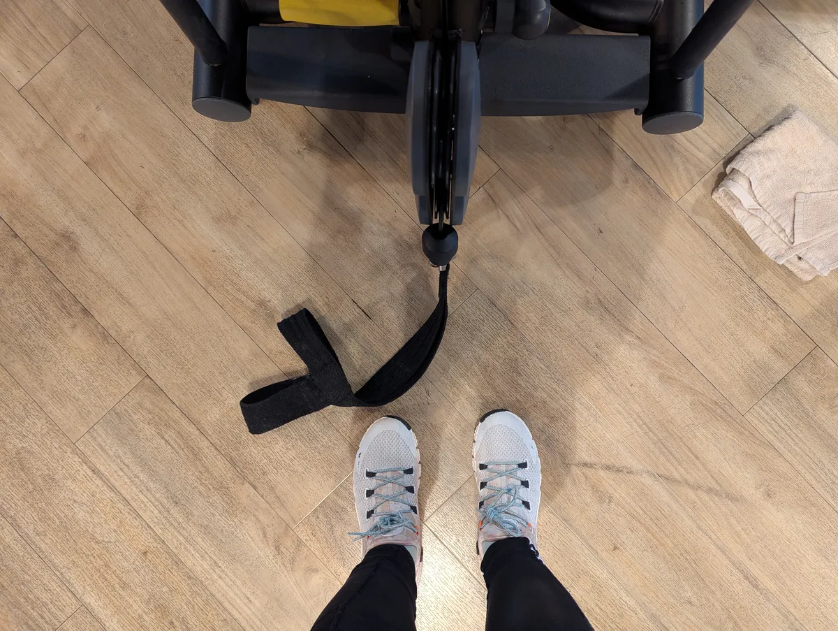 Peige's shoes standing in front of a gym machine