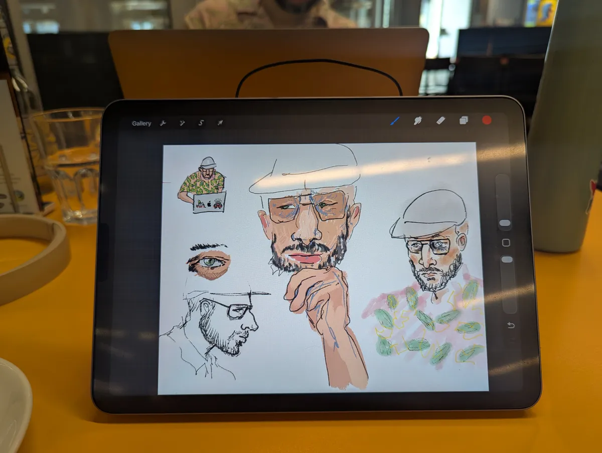 Propped up iPad with sketches of Daniel on Procreate.