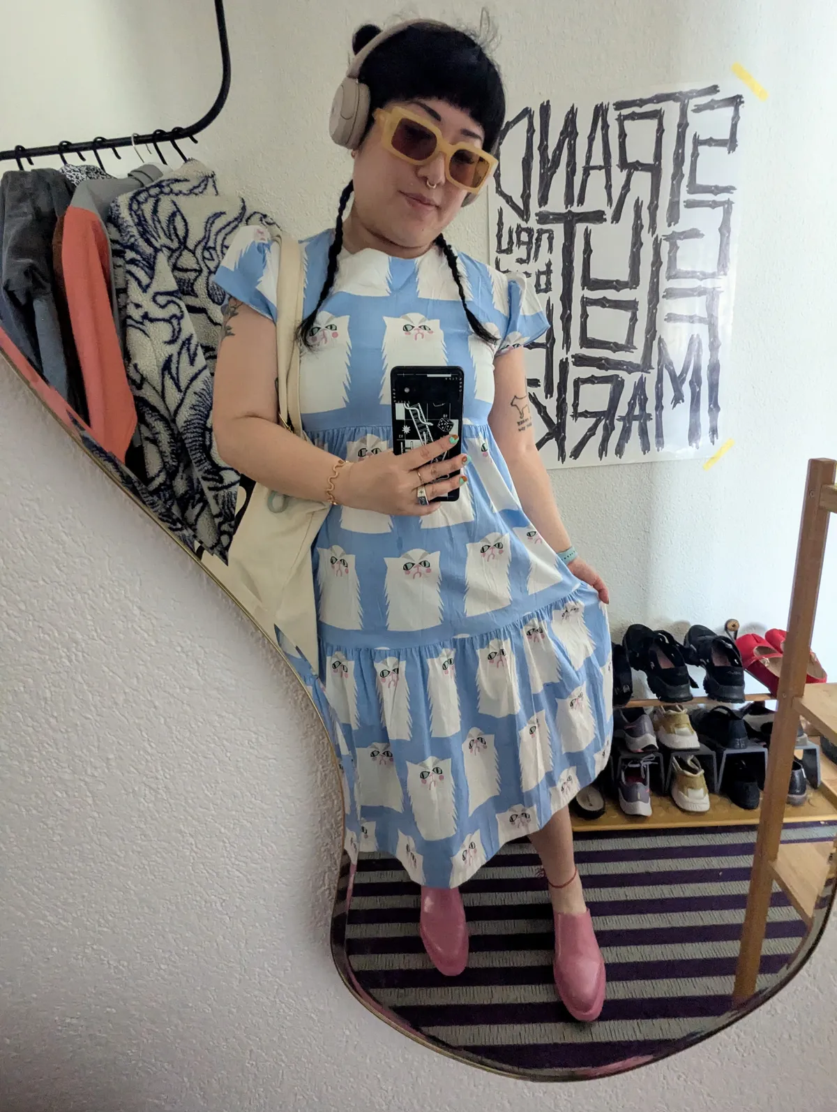 Peige wearing a light blue dress with a pattern of white cats.