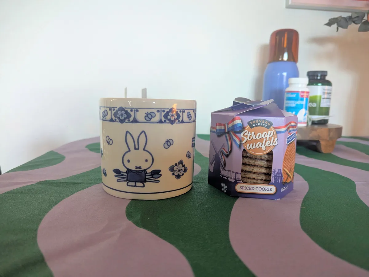 A Miffy x Delftware container next to a package of spiced cookie flavored stroopwaffels.