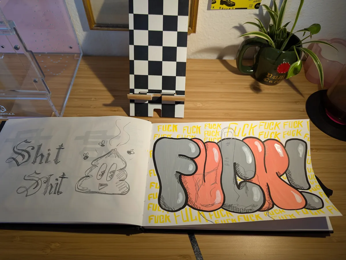 An open sketchbook. One page says 