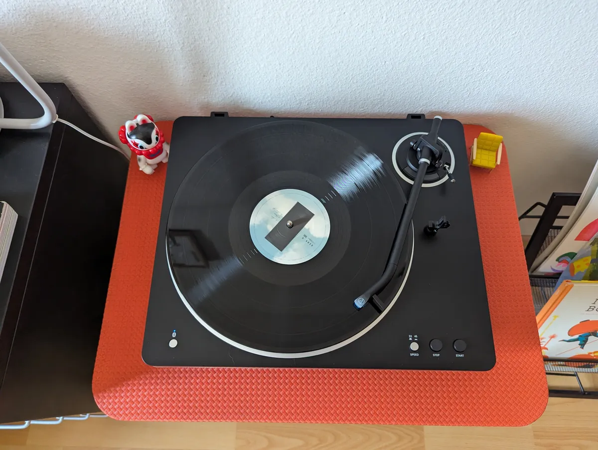 A record player spinning Kid Cudi's album, 