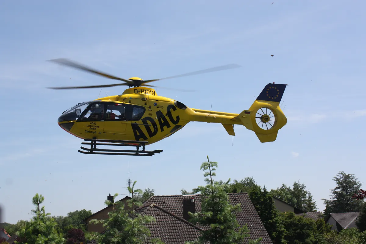 A yellow medical helicopter with the letters 