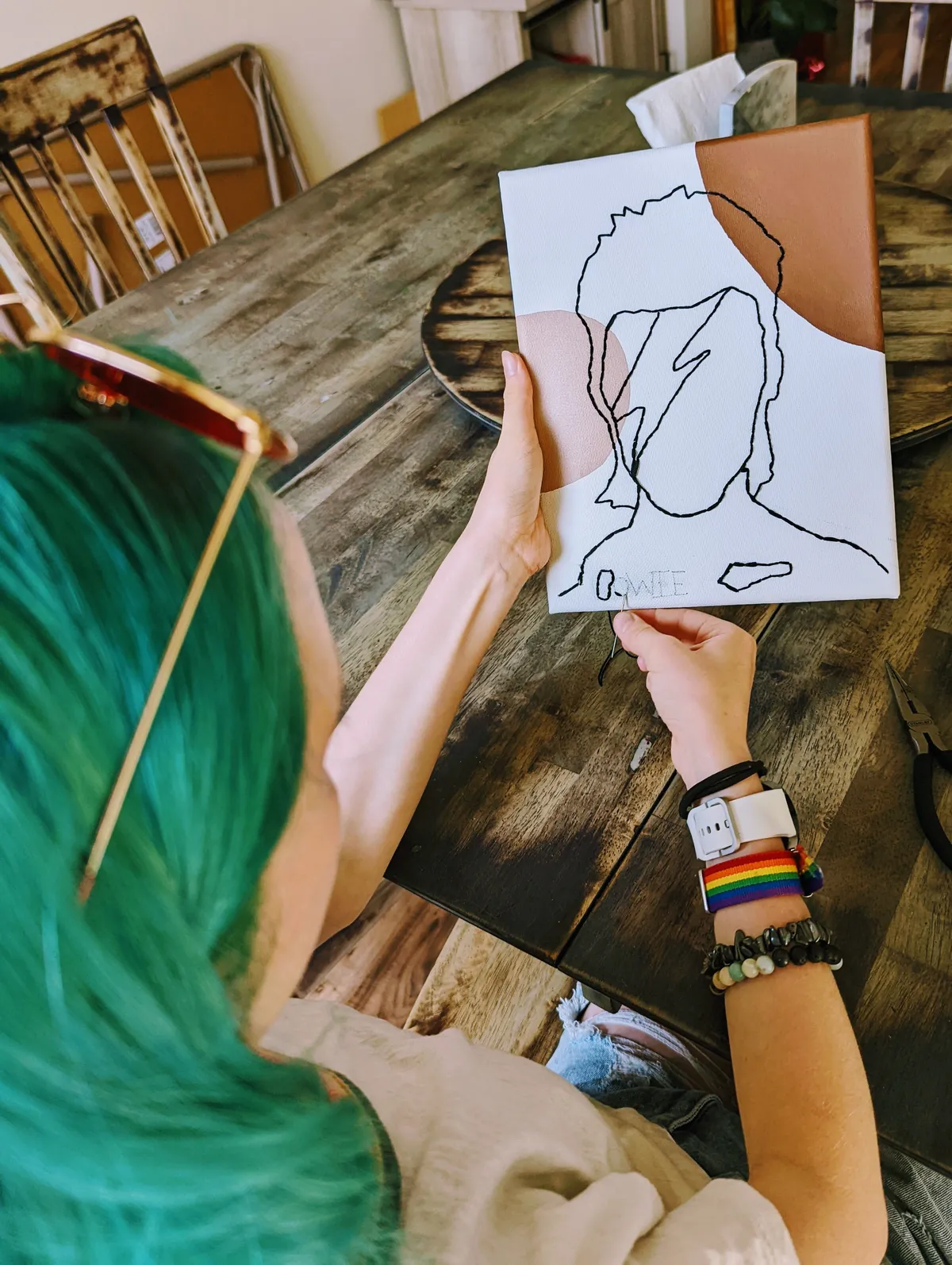 my daughter doing a canvas needlepoint portrait of David Bowie