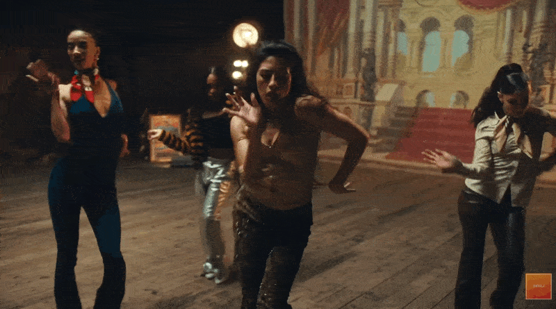Animated GIF created by blog author of dancers performing synchronized choreography in a continuous tracking shot from Jungle's 