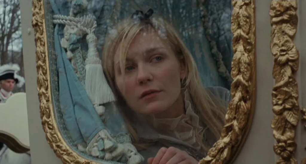 Kirsten Dunst in the movie Marie Antoinette (2006), looking out the window of her ornate carriage.