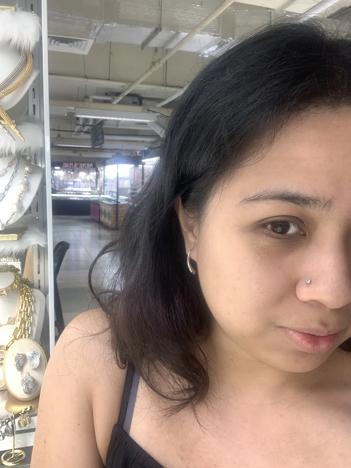 A selfie of half my face showing a silver thin drop earring.