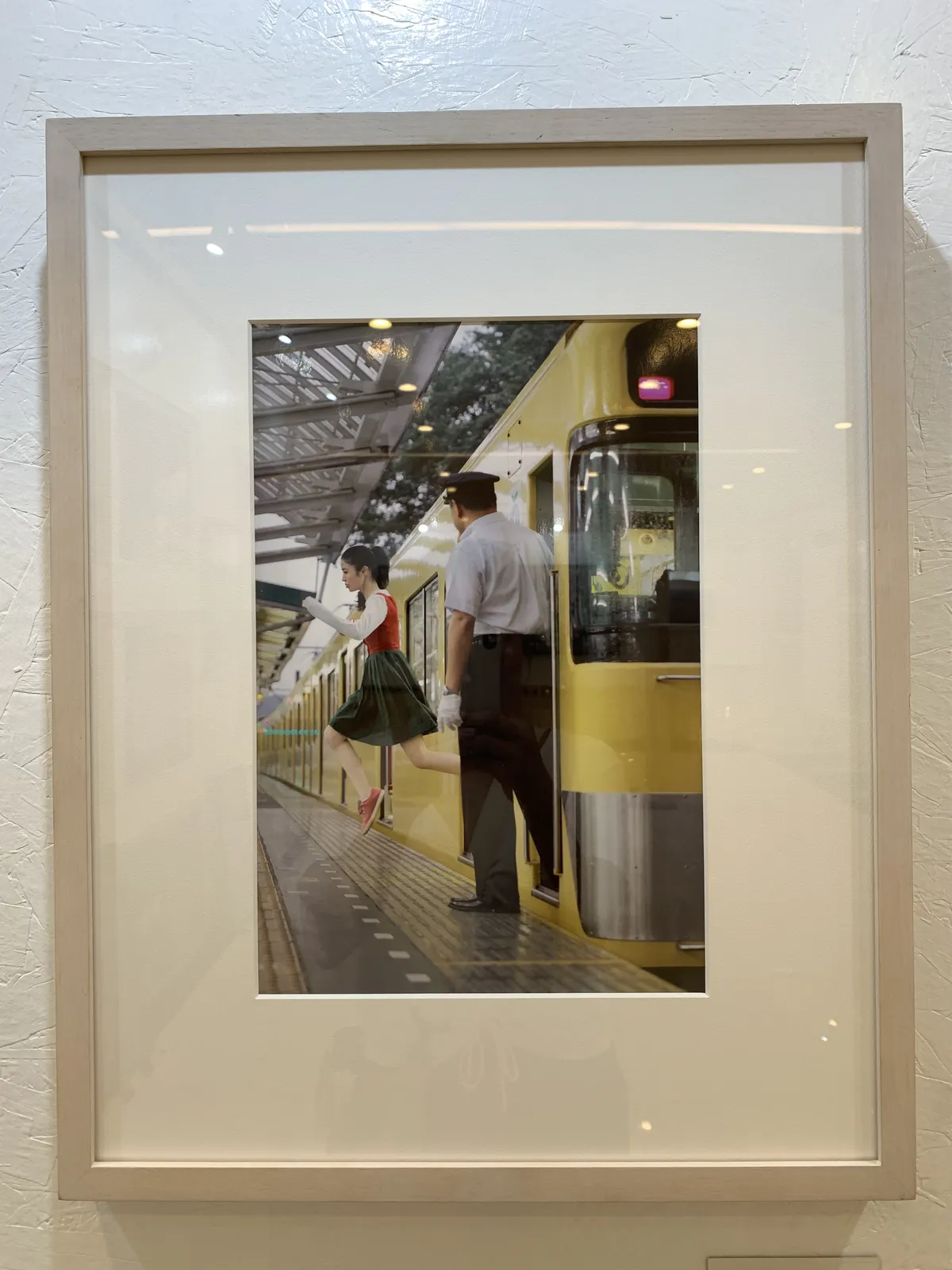 A young woman dressed nicely in a skirt levitates out of the coach of a train, posing as if she's ready for a run. A train usher stares at her in the foreground.