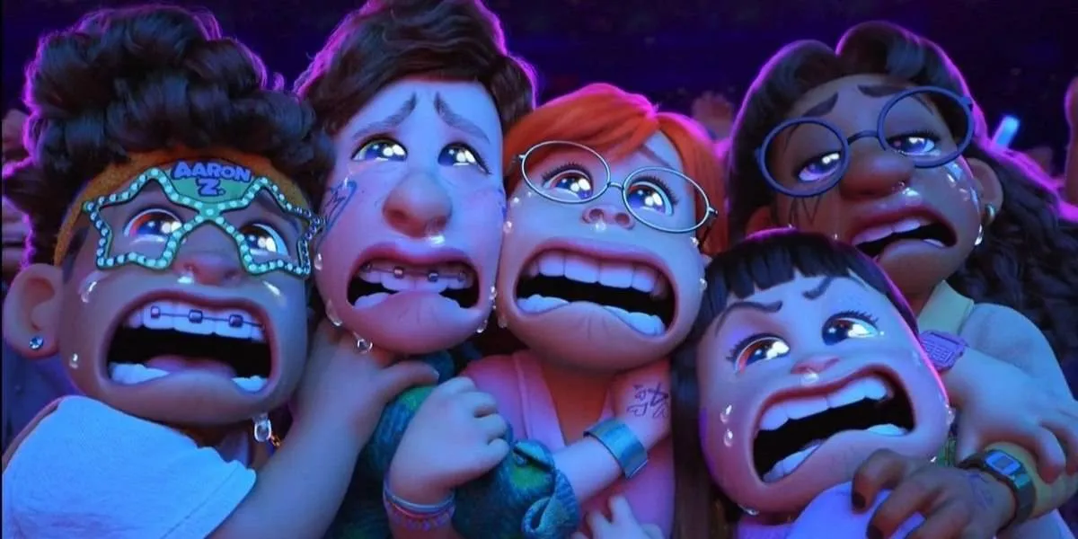 A screencap of the movie Turning Red, where cute teenage girls are crying and staring agape at the stage during a concert of their favorite boy band.