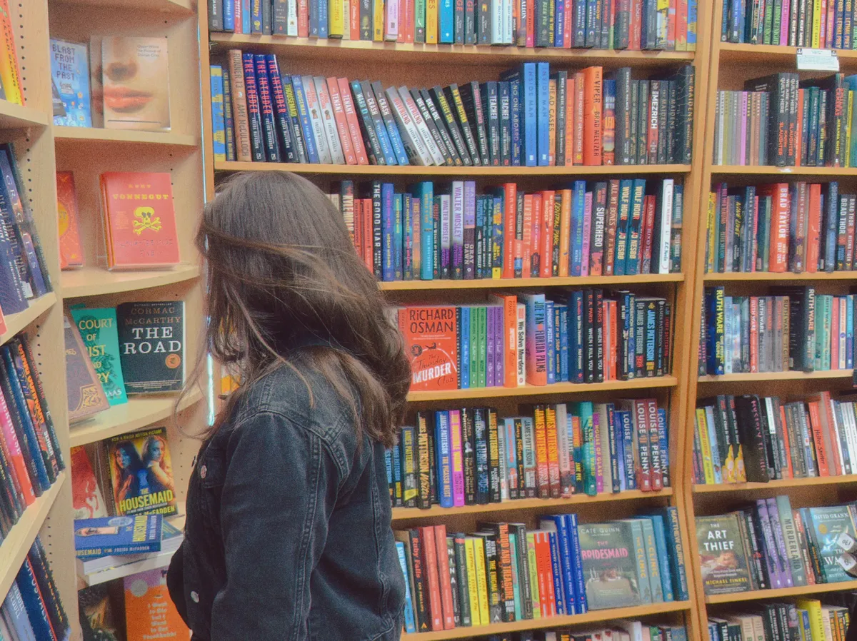The back of my head as I look at bookshelves