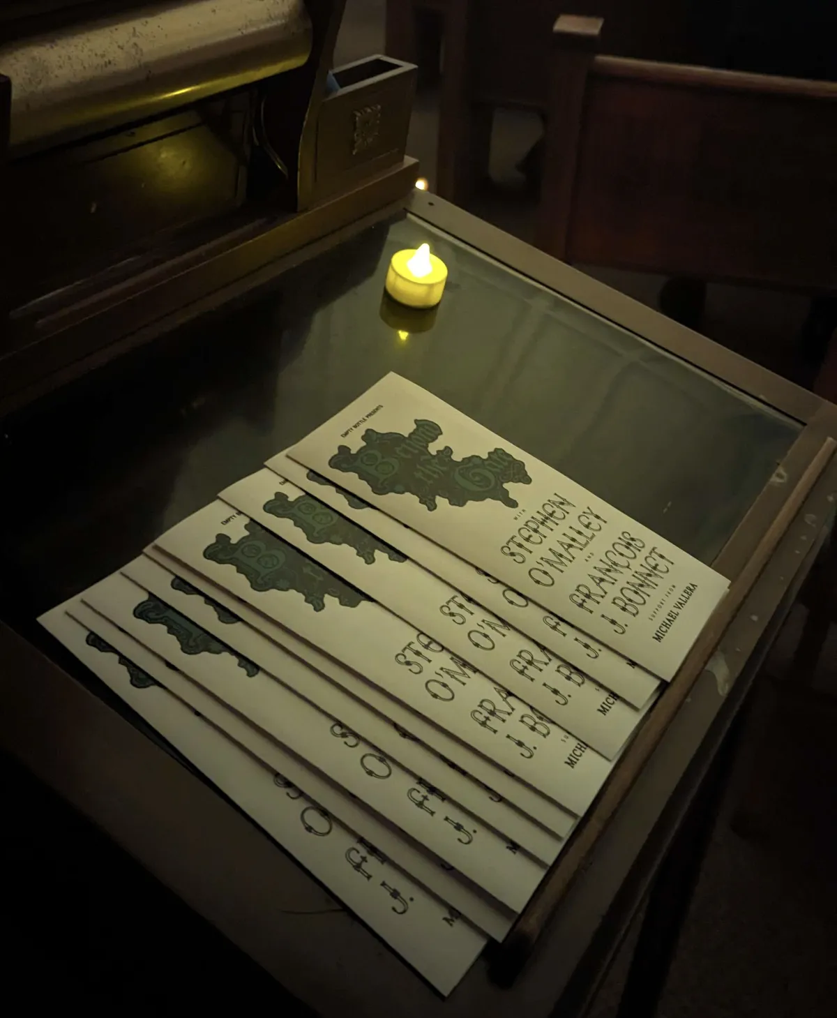 Programs for the concert in a neat pile on a podium