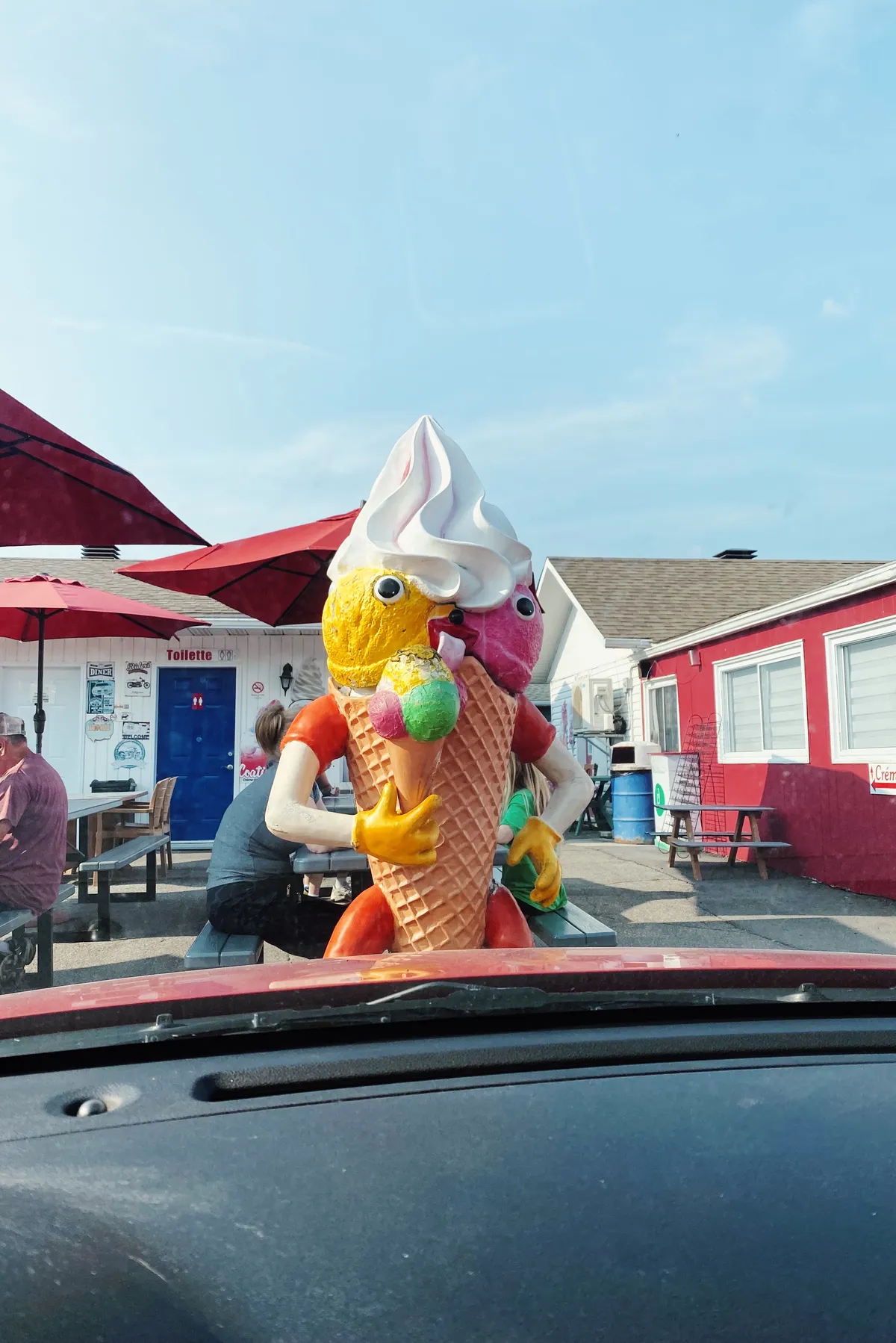 A statue of a funny ice cream cone that holds another ice cream cone