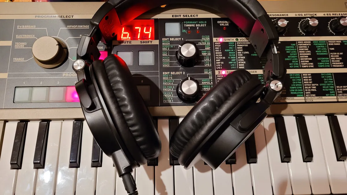 A pair of headphones resting on a Microkorg