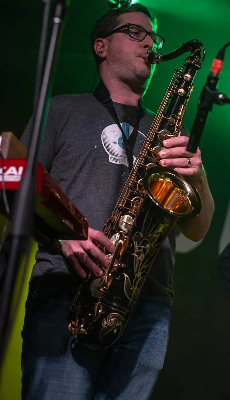 A person playing saxophone on stage