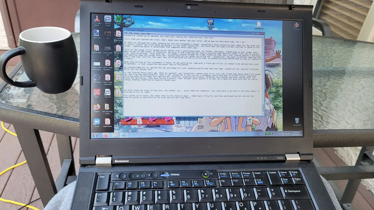 An open laptop and a coffee mug