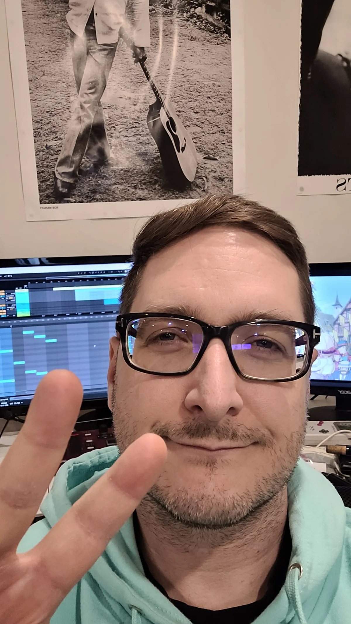 A person poses for photo, giving a "peace" sign.