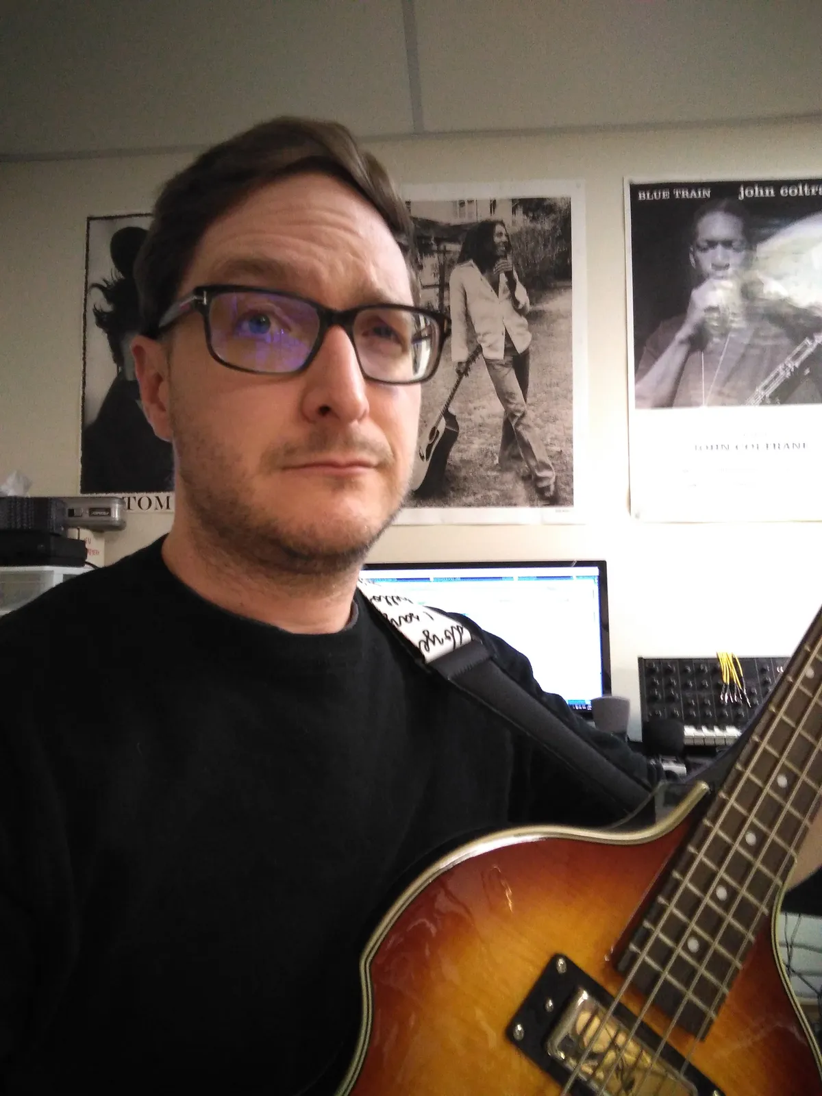 A person holding a bass guitar