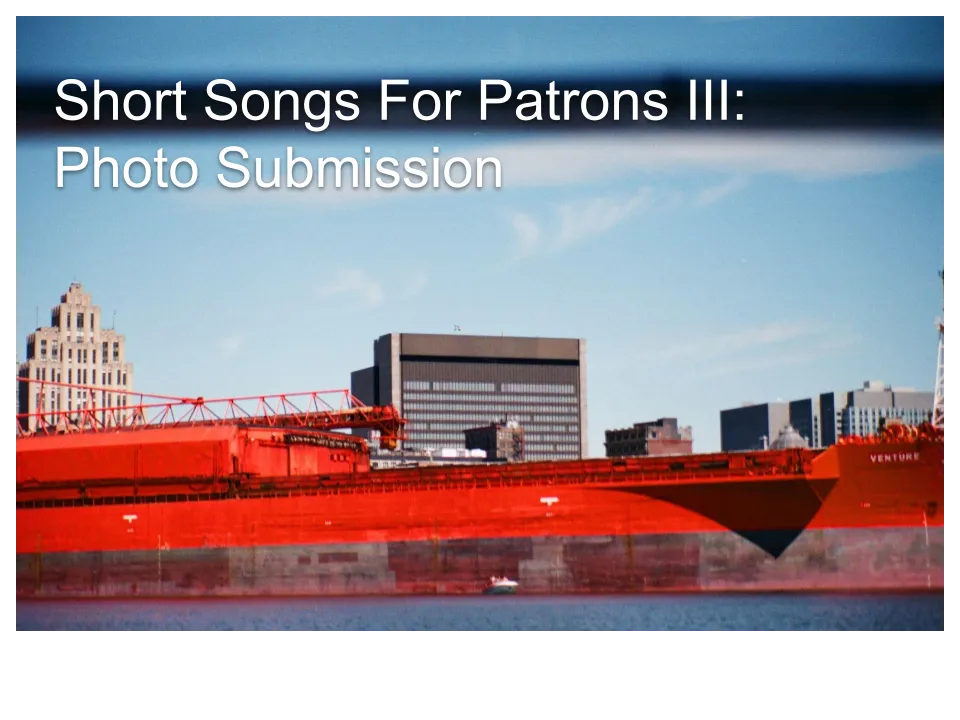 A photo of a cargo ship with some of Montreal in the background. Overlaid text reads, "Short Songs For Patrons III: Photo Submission"