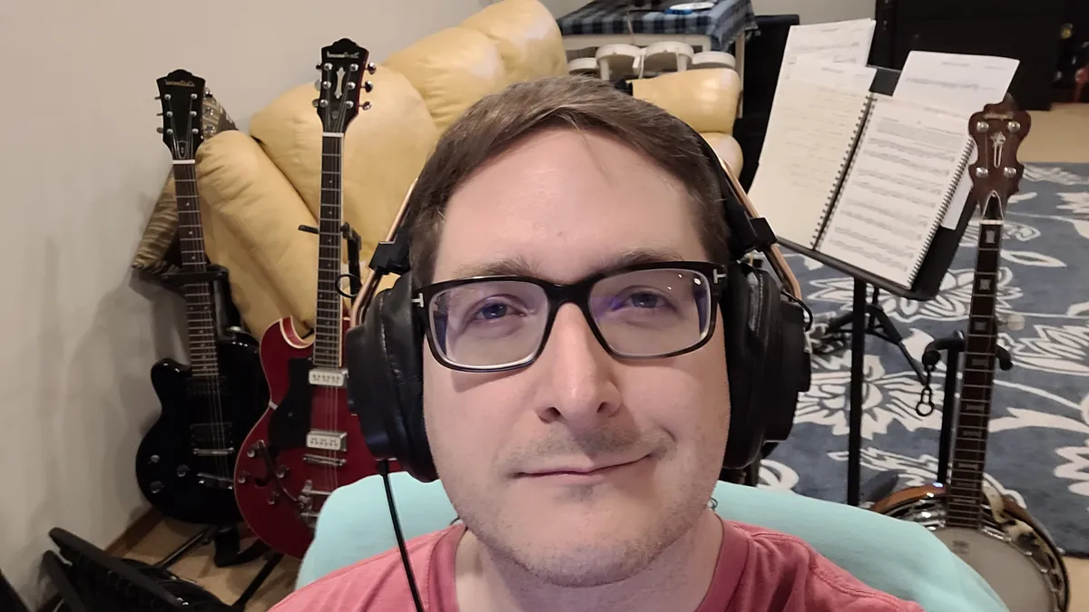 A selfie of a person in a home music studio
