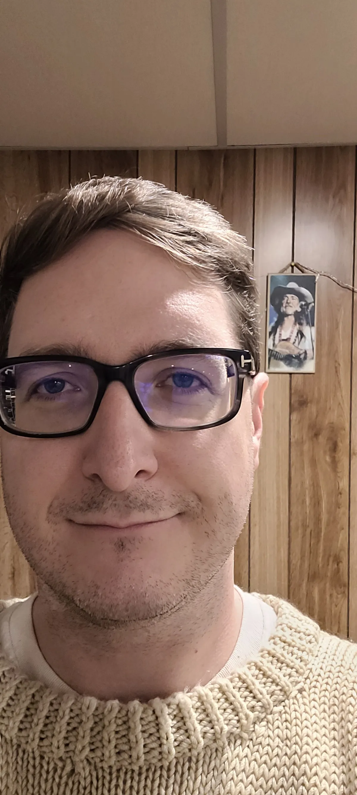 A selfie of a person wearing glasses