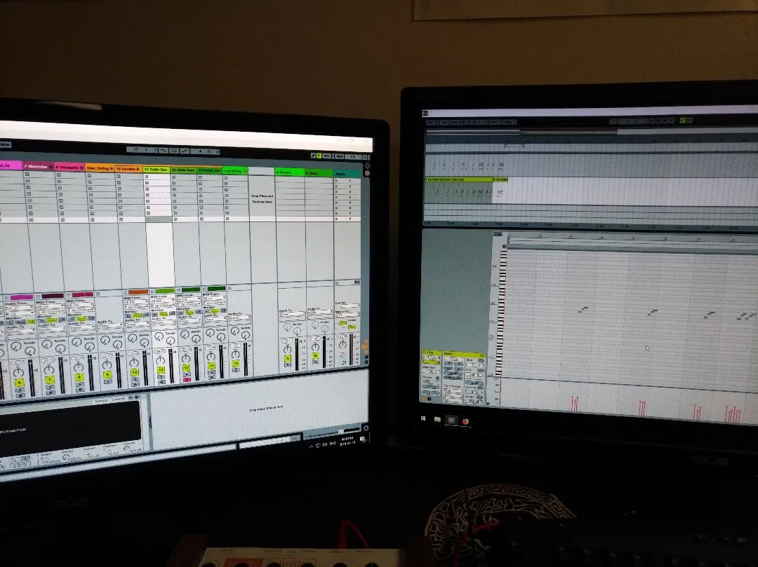 Two computer monitors in the dark
