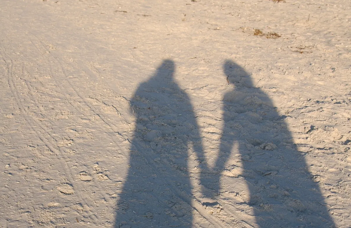 holding_hands_shadow_on_sand_edited