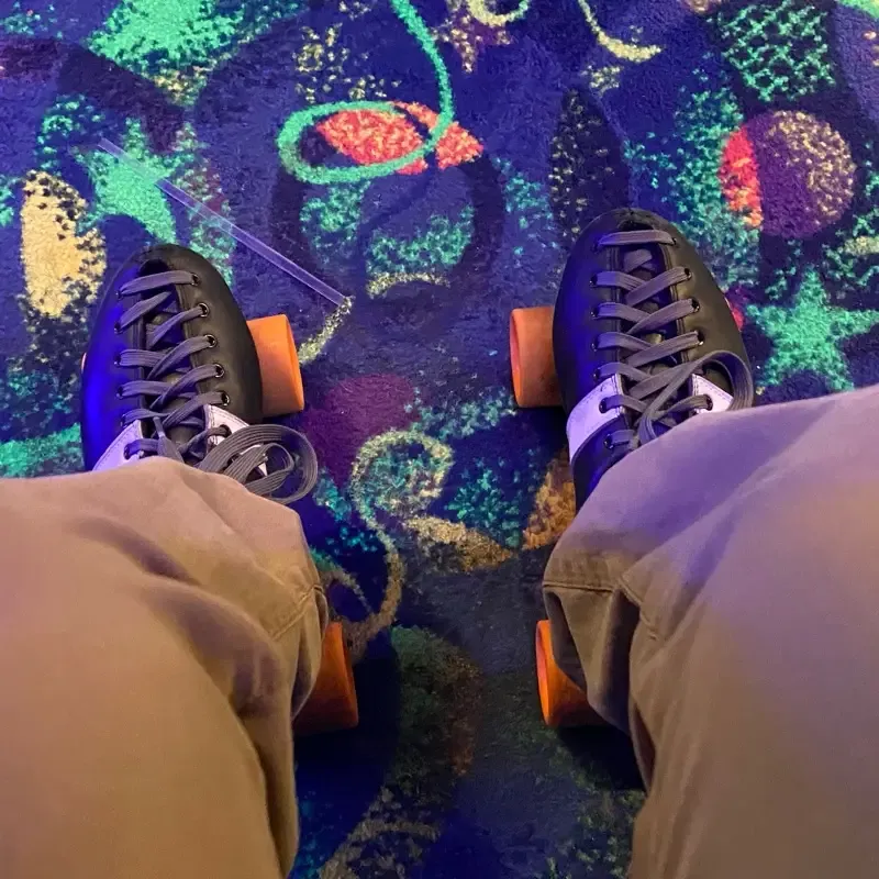Looking down at my roller skates from above and admiring the garish pattern of the rug.