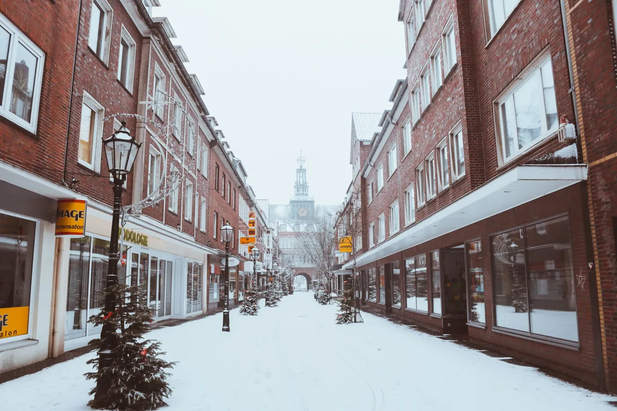 Snowy Field Near Buildings