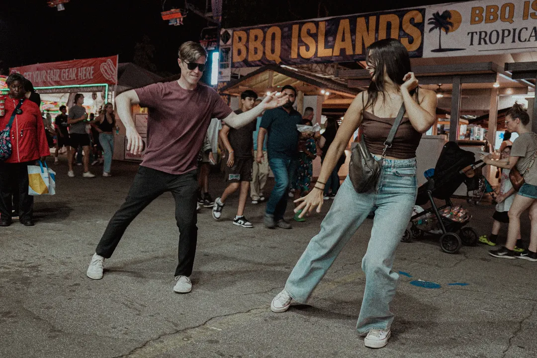 20250512 Clara and Jon dancing in front of passersby