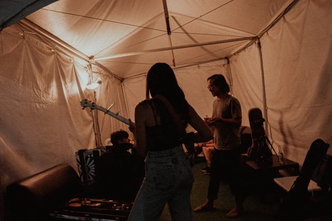 20250512 Streetlight Cadence backstage in a dimly lit tent