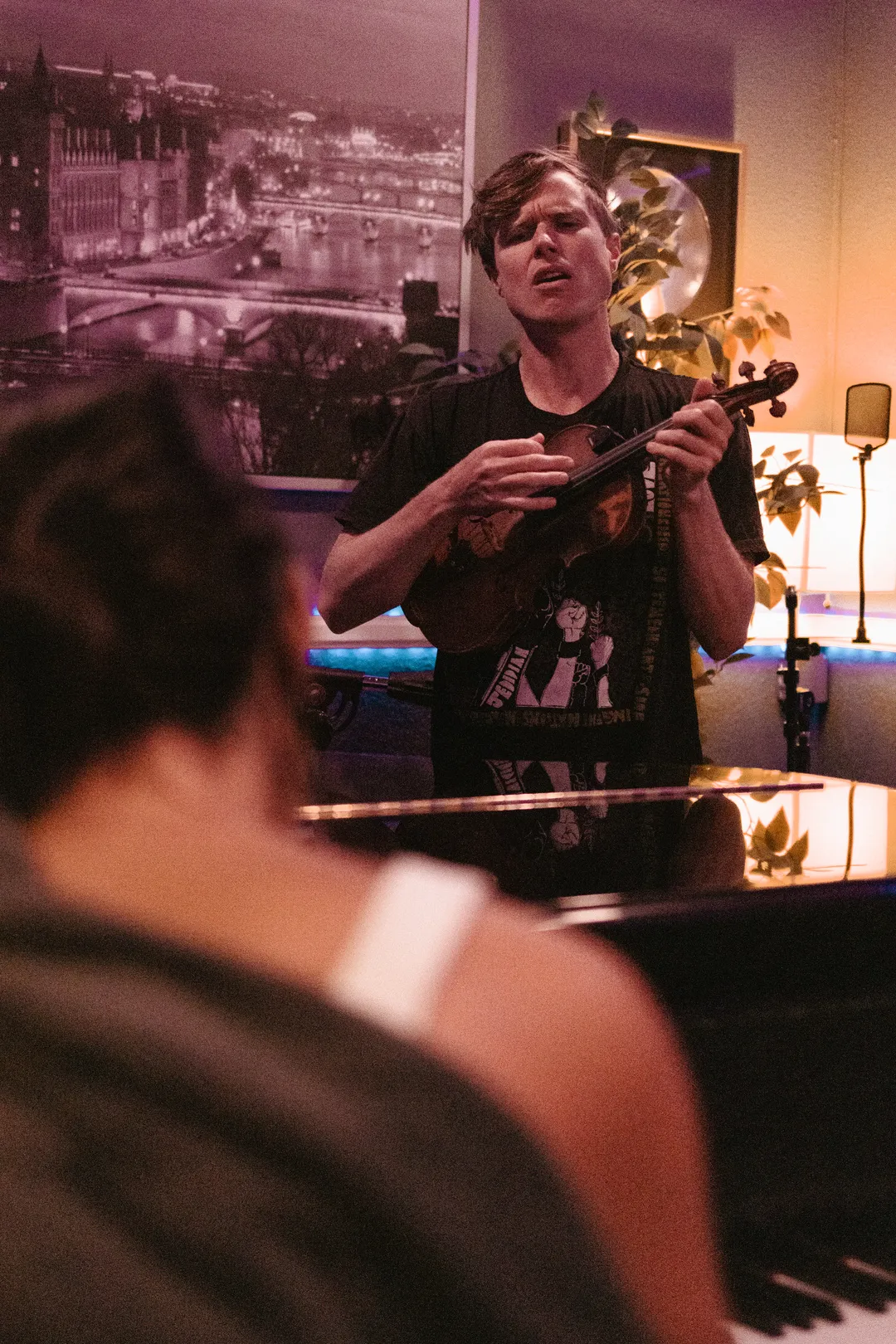 20250908 Jon strumming a violin while Clara is on piano