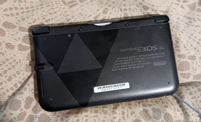 The back of my 3DS showing the Triforce on a black surface