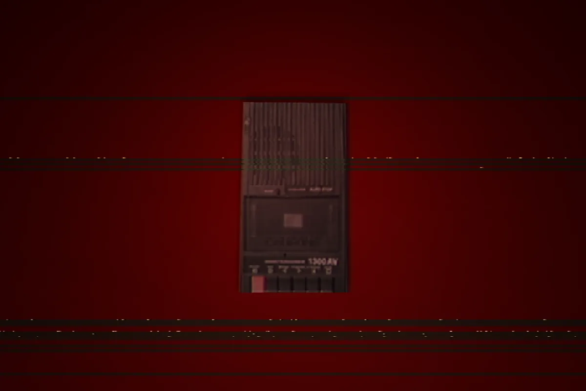 an old tape player lying on a red surface with scanlines over the image
