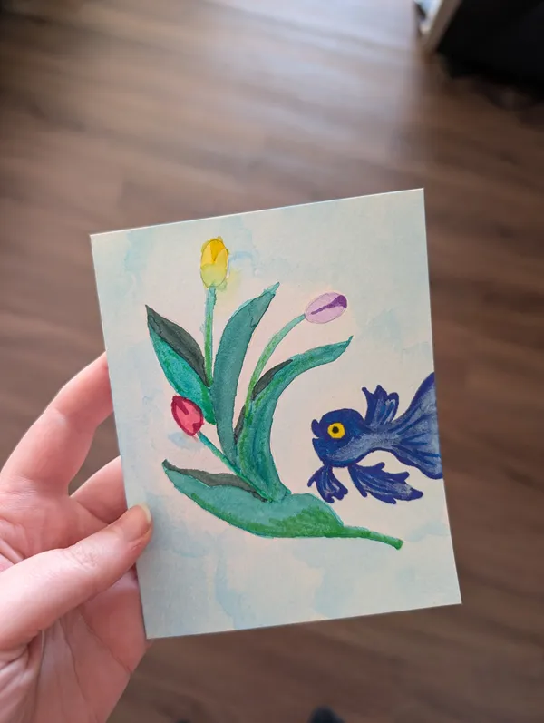 Painting of a blue fish looking at tulips