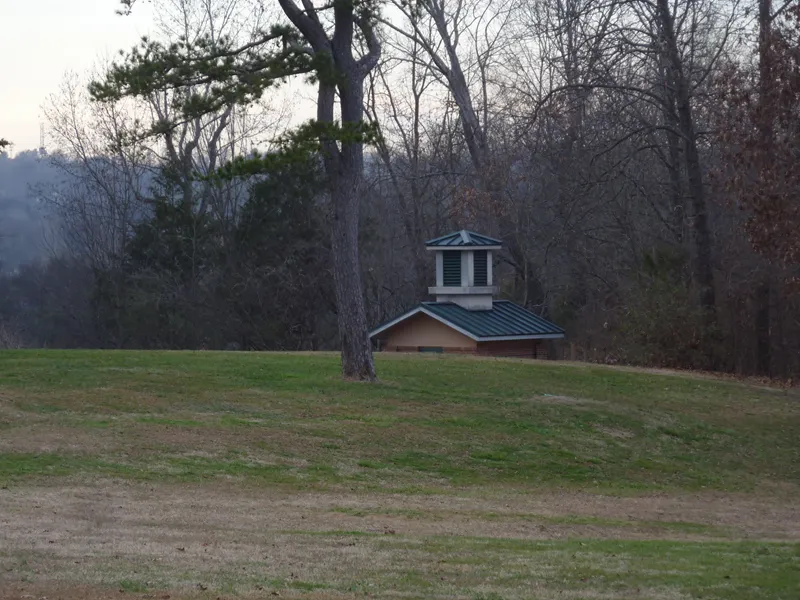 Top of a building beneath a hill