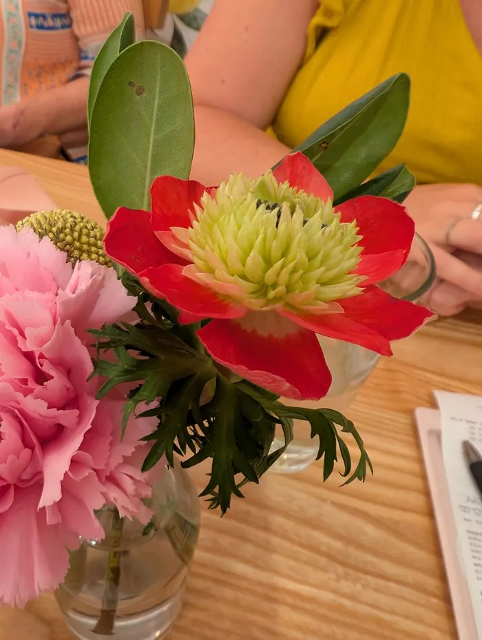 a small bouquet of brightly colored flowers in a vase